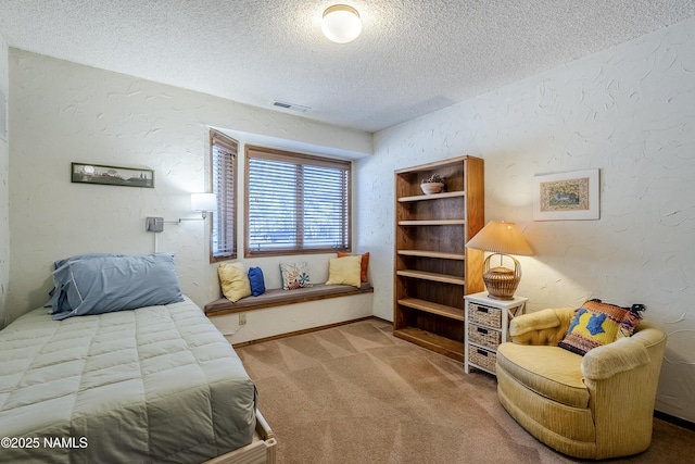 bedroom featuring a textured ceiling and carpet flooring