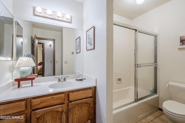 full bathroom with shower / bath combination with glass door, vanity, toilet, and tile patterned flooring