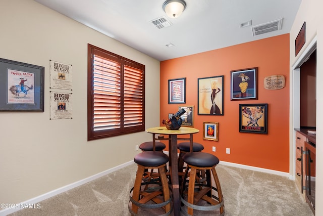 dining space featuring light colored carpet