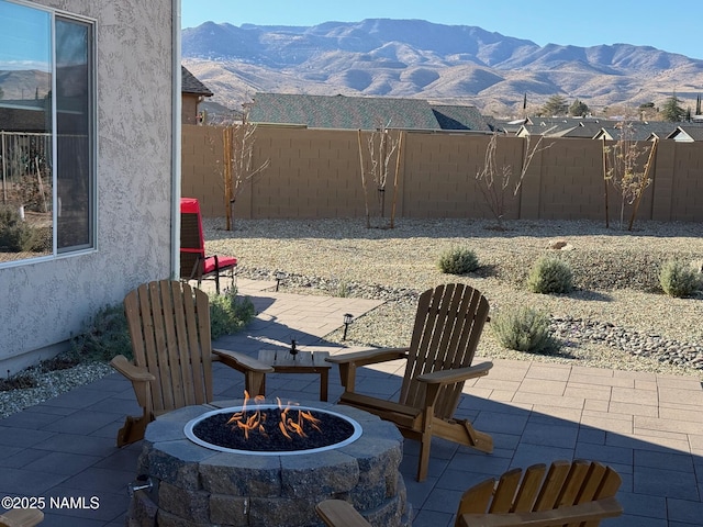 view of patio featuring a mountain view and an outdoor fire pit