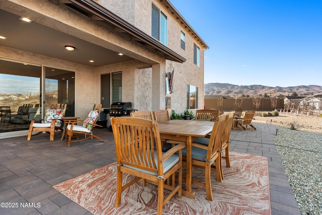 view of patio featuring a mountain view and a grill