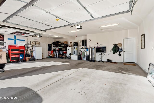 garage featuring white fridge and a garage door opener