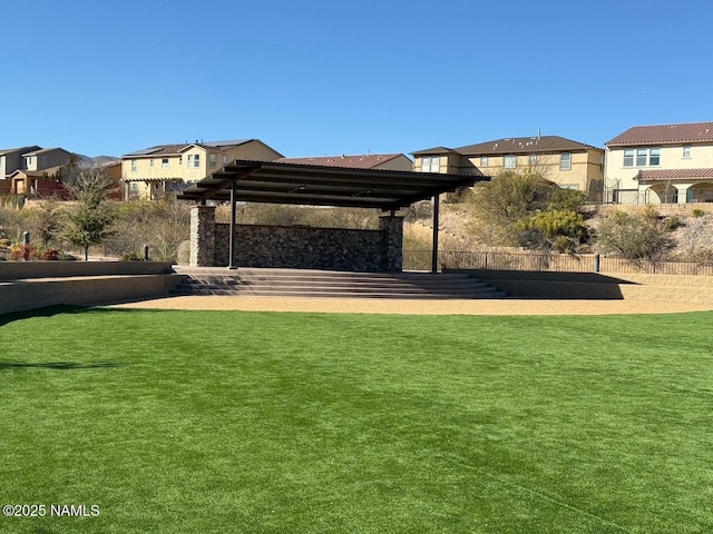 view of property's community with a lawn