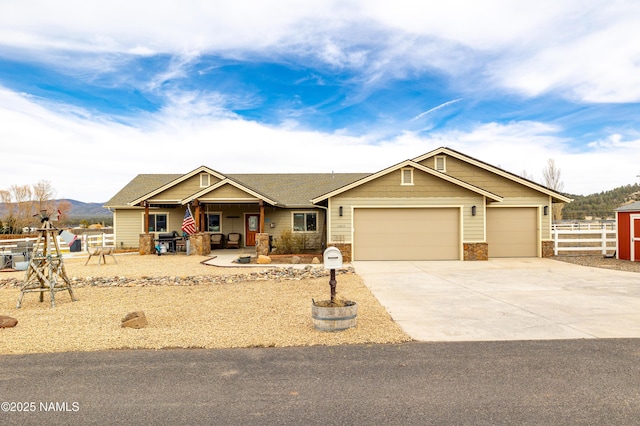 11265 N Zady Ln, Flagstaff, AZ 86004 - view of front facade featuring covered porch, a garage, driveway, and stone siding
