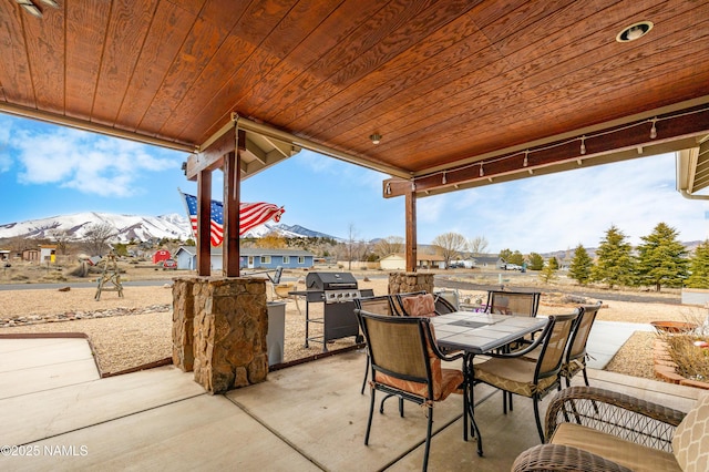 11265 N Zady Ln, Flagstaff, AZ 86004 - view of patio / terrace with a mountain view, outdoor dining space, and area for grilling
