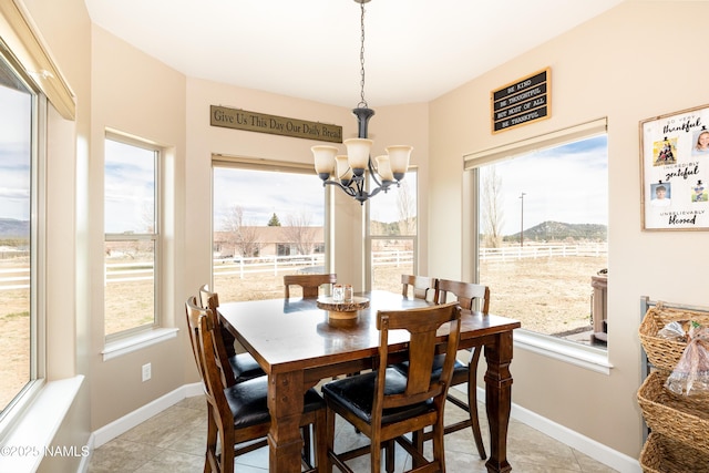 11265 N Zady Ln, Flagstaff, AZ 86004 - dining room with a chandelier, healthy amount of natural light, light tile patterned floors, and baseboards