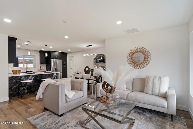 3707 E Amelia Ave, Phoenix, AZ 85018 - living room with wood finished floors and recessed lighting