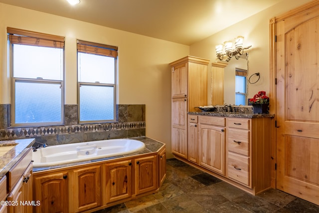 2163 S Highland Mesa Rd, Flagstaff, AZ 86001 - bathroom with vanity, a wealth of natural light, and a tub to relax in