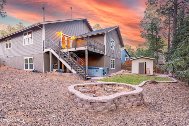 2163 S Highland Mesa Rd, Flagstaff, AZ 86001 - back house at dusk featuring a hot tub and a storage unit