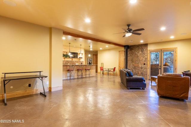 2163 S Highland Mesa Rd, Flagstaff, AZ 86001 - living room with a wood stove, beamed ceiling, and ceiling fan