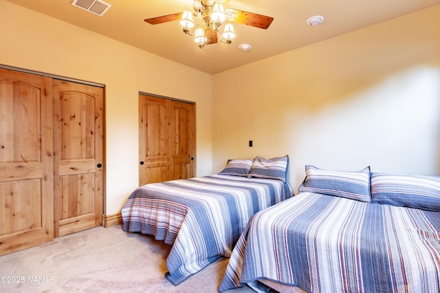 2163 S Highland Mesa Rd, Flagstaff, AZ 86001 - bedroom with light colored carpet, two closets, and ceiling fan