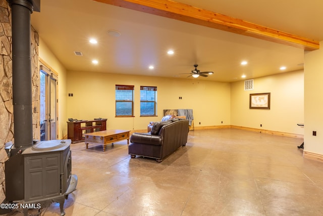 2163 S Highland Mesa Rd, Flagstaff, AZ 86001 - living room with a wood stove, beamed ceiling, and ceiling fan