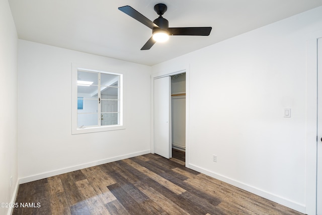 2814 N Patterson Blvd, Flagstaff, AZ 86004 - unfurnished bedroom featuring dark wood-type flooring, baseboards, a closet, and a ceiling fan