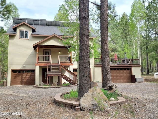 view of front of house featuring a garage and a wooden deck