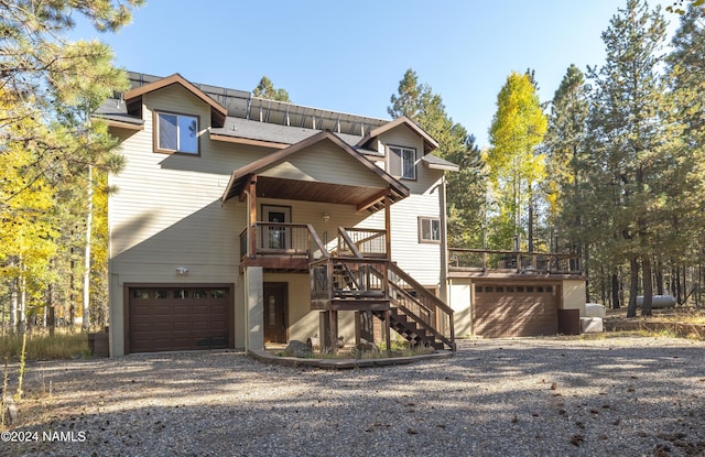 view of front of property featuring a garage and a wooden deck