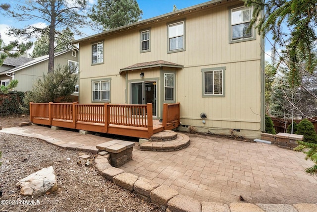 back of house with a deck and a patio area