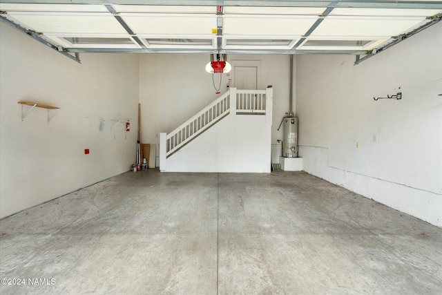 garage with a garage door opener and water heater