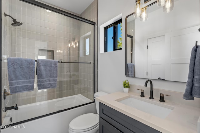 302 W Oak Ave Unit 5, Flagstaff, AZ 86001 - full bathroom featuring vanity, bath / shower combo with glass door, and toilet