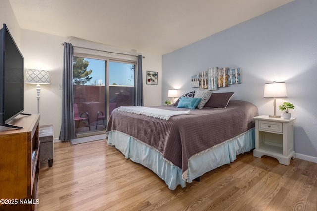 bedroom featuring access to outside, light wood-style flooring, and baseboards