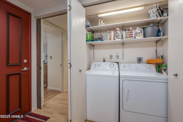 laundry room featuring light wood-style floors, laundry area, and washing machine and clothes dryer