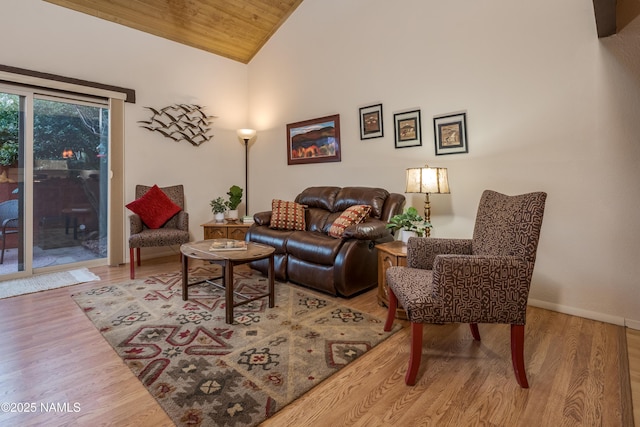 living area featuring high vaulted ceiling, wood ceiling, baseboards, and wood finished floors