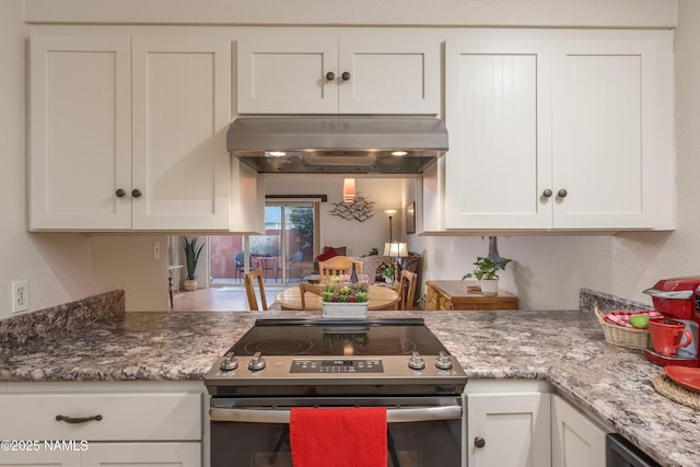 kitchen with under cabinet range hood, electric range, stone counters, and white cabinets