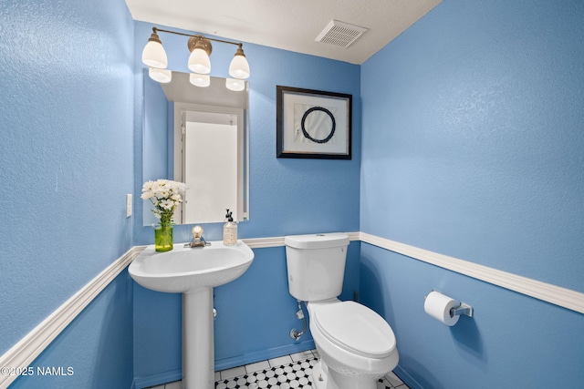 bathroom featuring sink and toilet