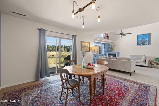 dining area featuring ceiling fan and carpet flooring