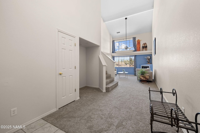 interior space with carpet floors and a towering ceiling