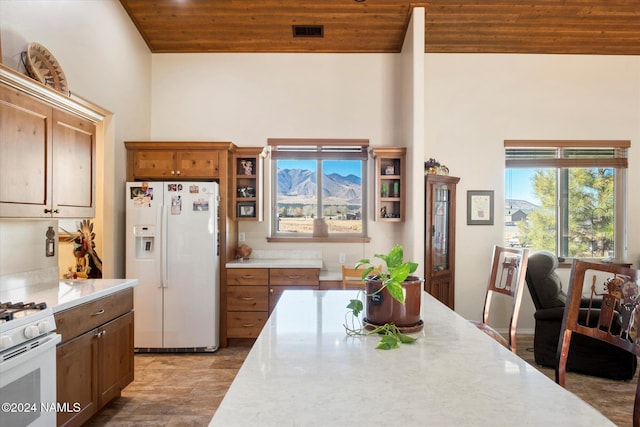 kitchen featuring wooden ceiling, white appliances, and lofted ceiling