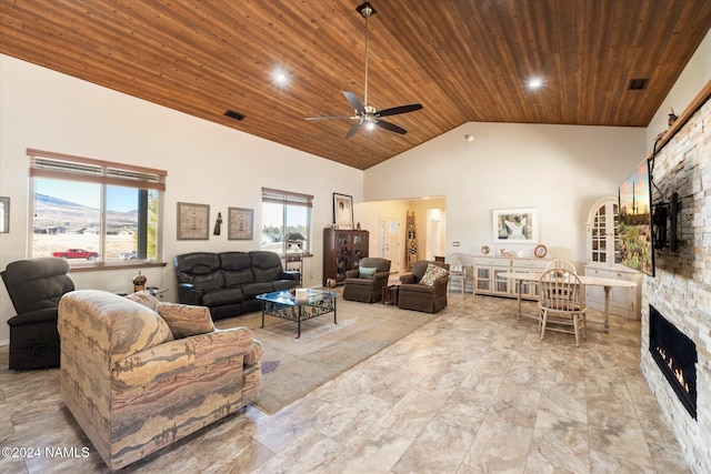 living room featuring wooden ceiling, high vaulted ceiling, and a stone fireplace