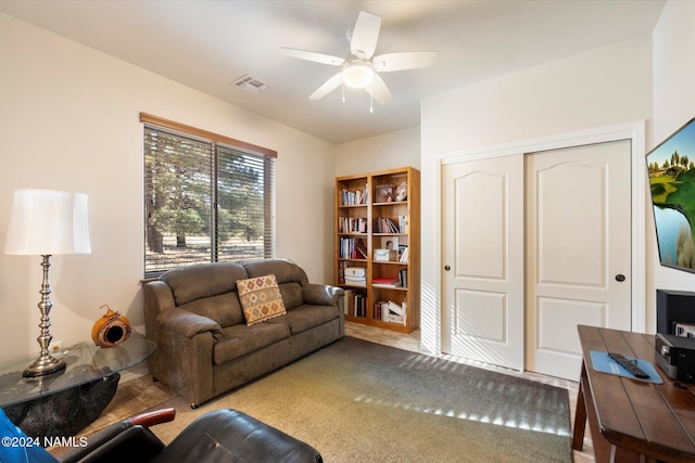 living room featuring ceiling fan and carpet flooring