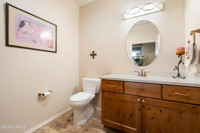 bathroom with toilet and vanity