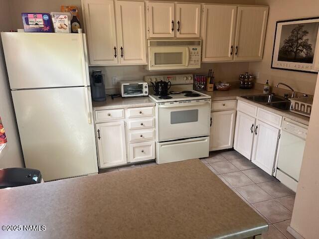 2065 N Country Club Dr, Flagstaff, AZ 86004 - kitchen with white appliances, a sink, light tile patterned floors, light countertops, and white cabinets
