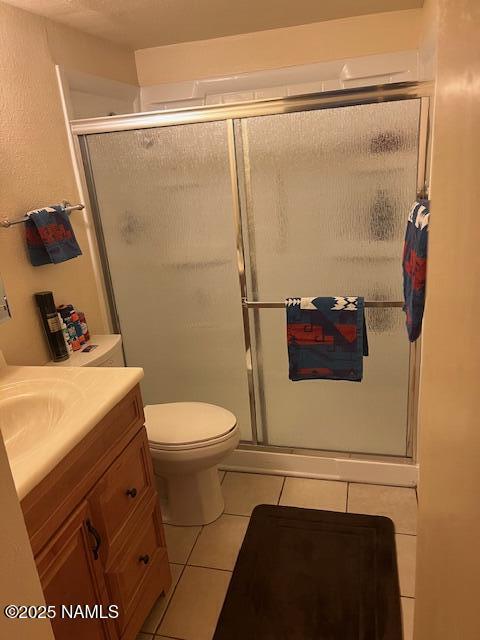 2065 N Country Club Dr, Flagstaff, AZ 86004 - full bathroom featuring tile patterned floors, vanity, a shower stall, and toilet