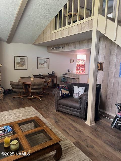 2065 N Country Club Dr, Flagstaff, AZ 86004 - living room with wooden walls, dark wood-style flooring, a textured ceiling, and vaulted ceiling