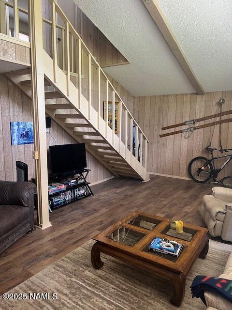 2065 N Country Club Dr, Flagstaff, AZ 86004 - living room with wood walls, wood finished floors, stairs, a textured ceiling, and baseboards