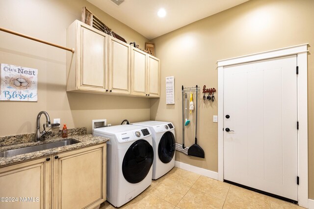 10833 Sage Rd, Flagstaff, AZ 86004 - clothes washing area featuring baseboards, washer and dryer, a sink, cabinet space, and light tile patterned flooring
