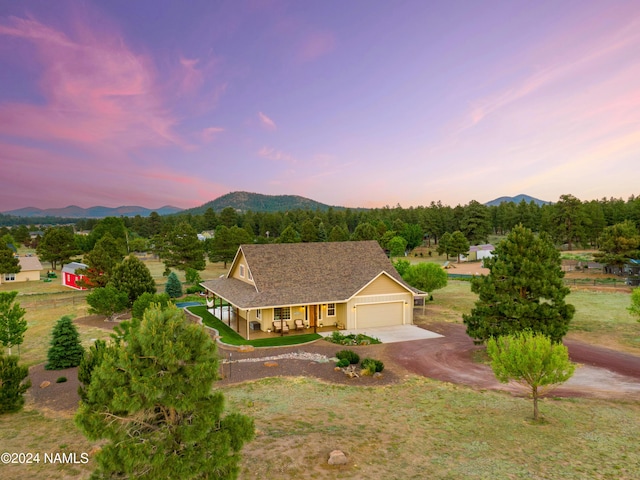 10833 Sage Rd, Flagstaff, AZ 86004 - view of front of house featuring a mountain view, a garage, and driveway