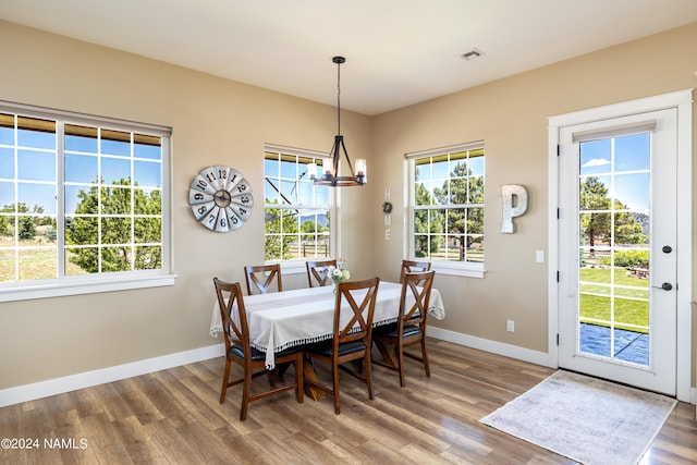 10833 Sage Rd, Flagstaff, AZ 86004 - dining space featuring visible vents, baseboards, a chandelier, and wood finished floors