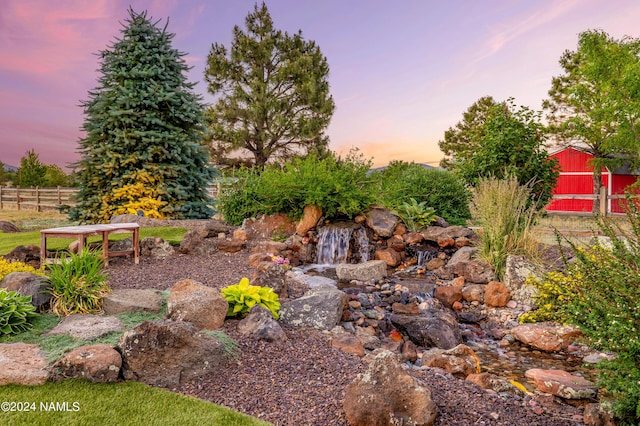 10833 Sage Rd, Flagstaff, AZ 86004 - yard at dusk featuring an outbuilding and fence