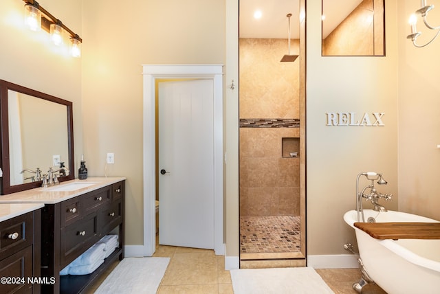 10833 Sage Rd, Flagstaff, AZ 86004 - full bath featuring a walk in shower, a freestanding tub, vanity, tile patterned floors, and baseboards