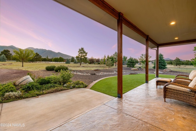 10833 Sage Rd, Flagstaff, AZ 86004 - patio terrace at dusk featuring a mountain view and a lawn