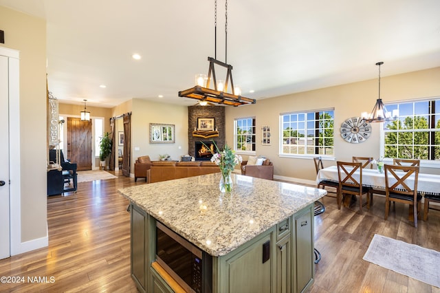 10833 Sage Rd, Flagstaff, AZ 86004 - kitchen featuring wood finished floors, stainless steel microwave, recessed lighting, and a wealth of natural light