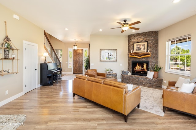 10833 Sage Rd, Flagstaff, AZ 86004 - living area featuring a stone fireplace, ceiling fan, recessed lighting, and light wood-style floors