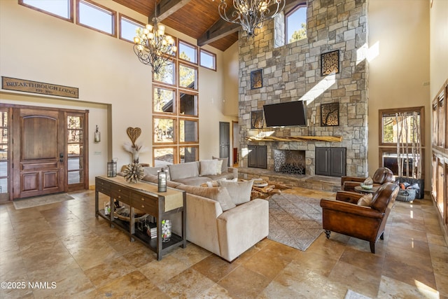 living room featuring beam ceiling, a fireplace, a notable chandelier, wood ceiling, and high vaulted ceiling