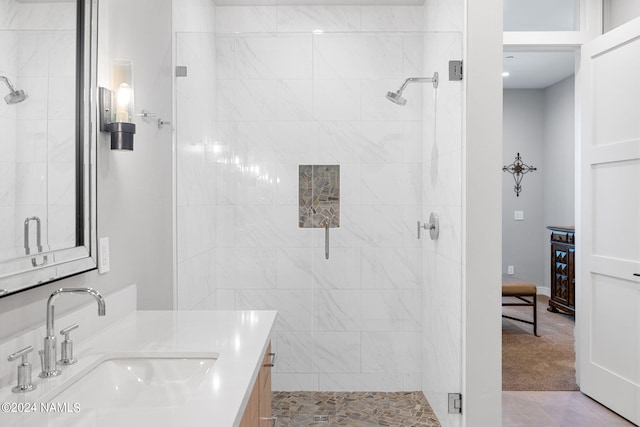 bathroom with a shower with shower door and vanity