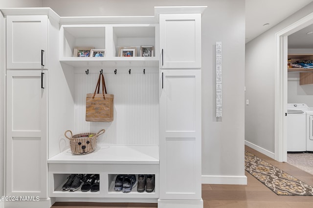 mudroom with washer and dryer and wood-type flooring