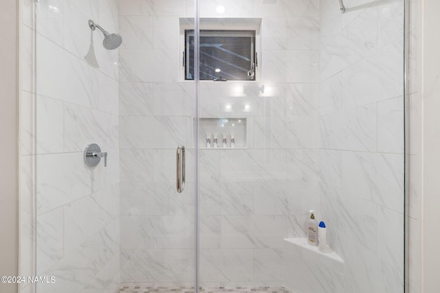 bathroom featuring a shower with door