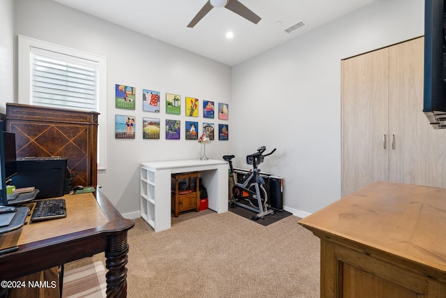 office area featuring light carpet and ceiling fan